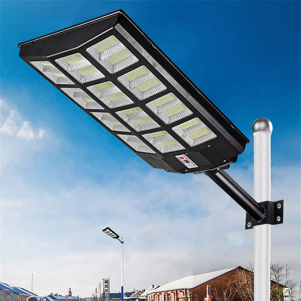 Black solar street light with dual lantern heads mounted on a decorative pole, each lantern featuring clear glass panels. The light stands 230 cm tall, Ideal for outdoor use in streets, gardens, or pathways.