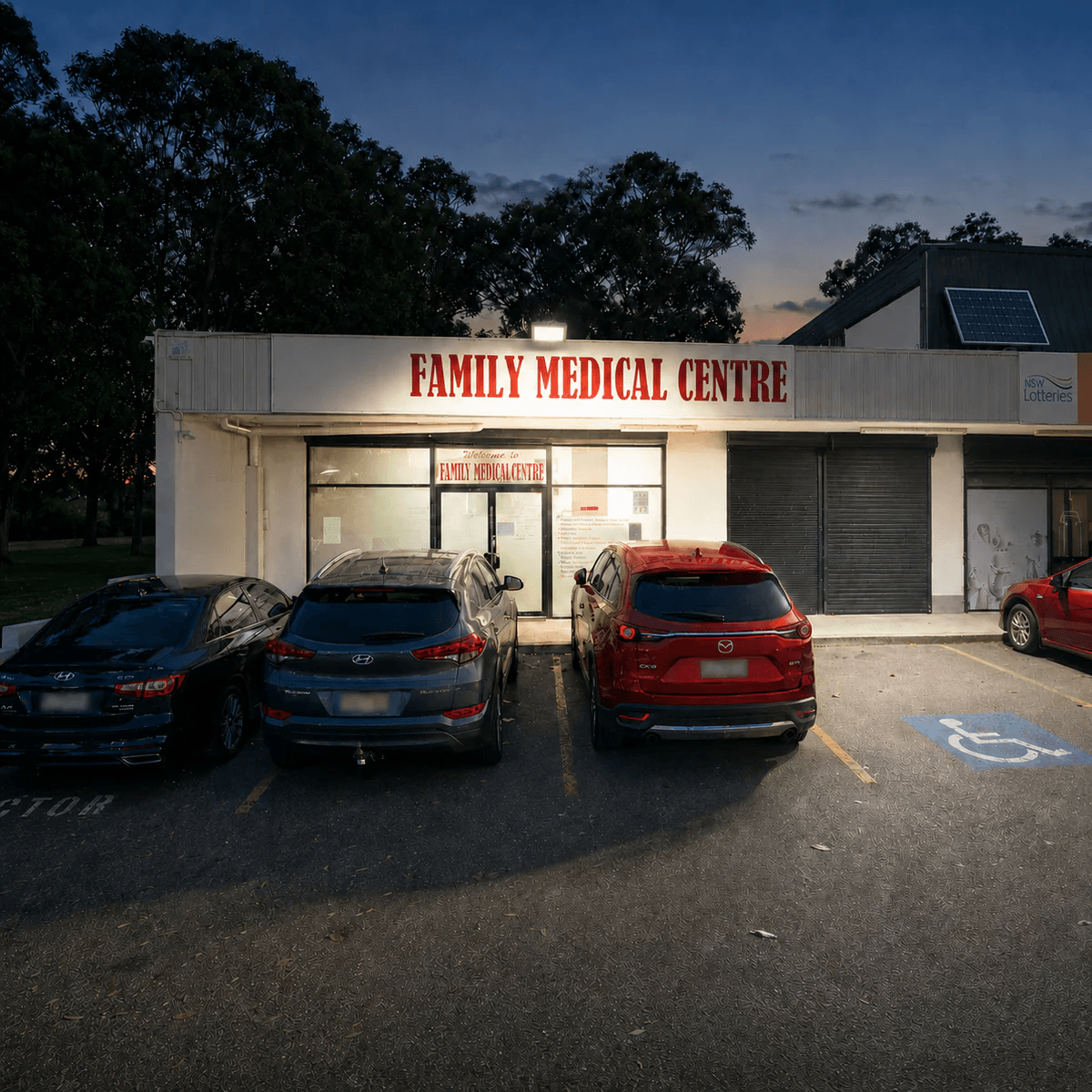 100W solar flood lamp with roof-mounted panel over a commercial depot entry. Weatherproof solar lights floodlights for Australian business premises.