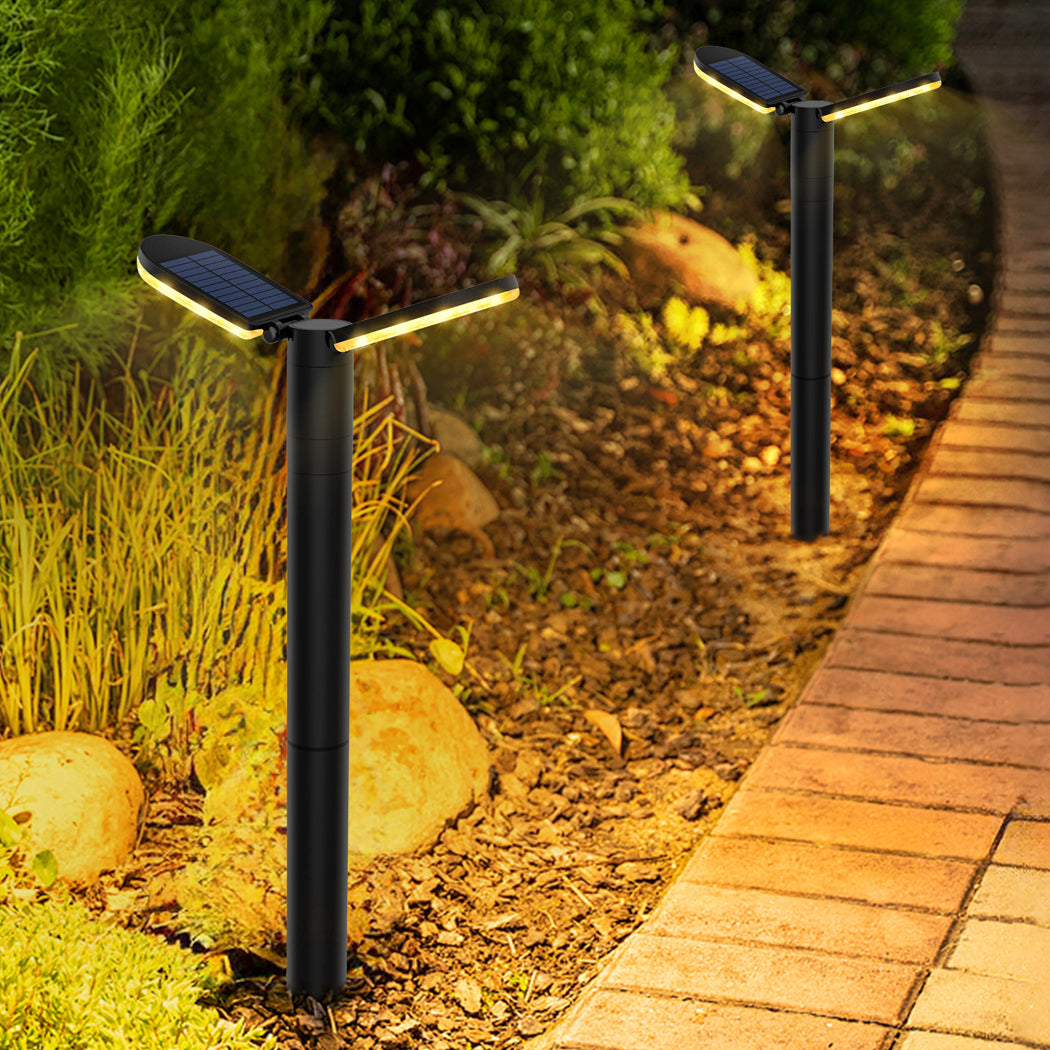 Solar pathway lights installed along a garden walkway at dusk automatically turning on