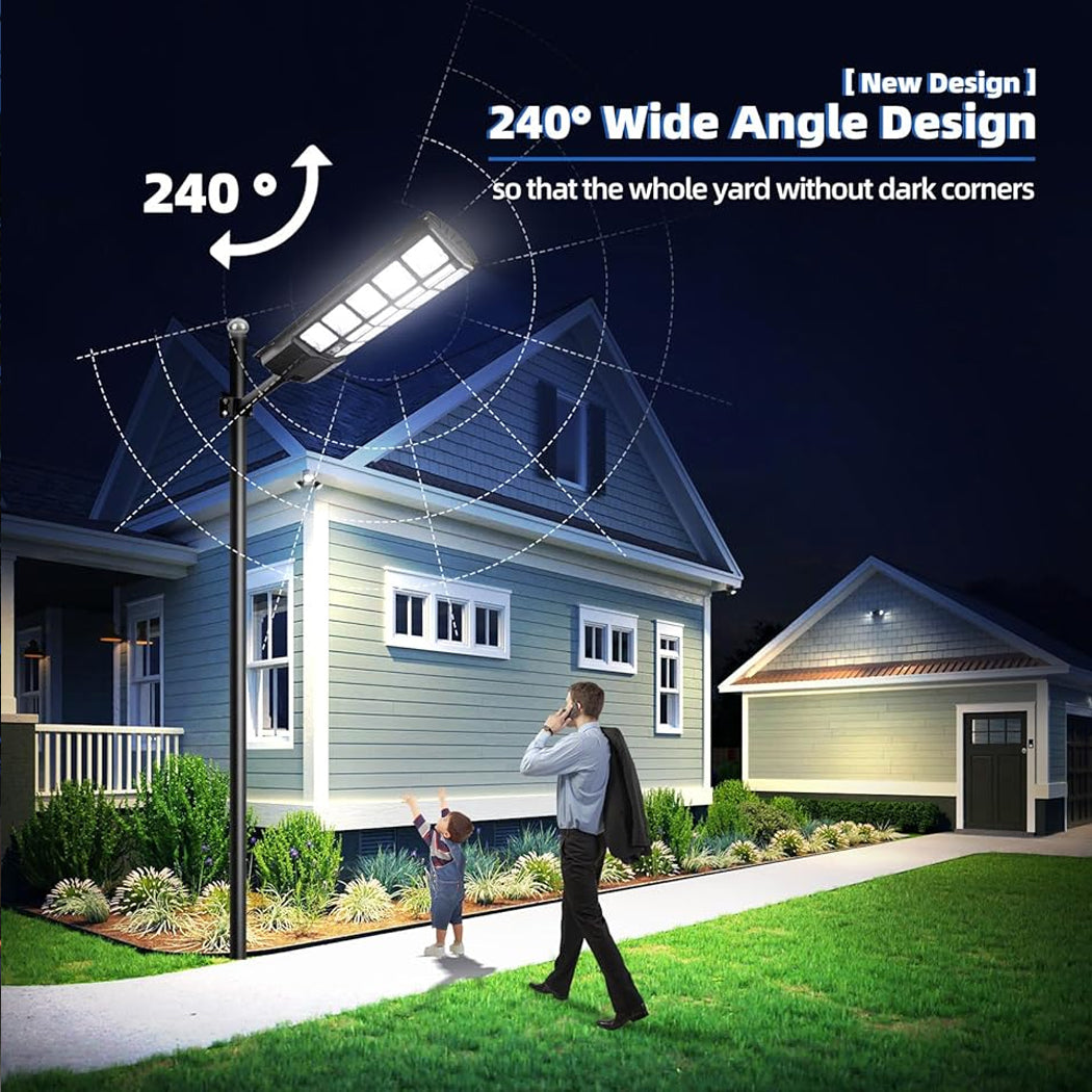 Nighttime scene with a Solareasy solar street light illuminating a front yard and footpath using a 240° wide-angle beam. A man and child walk safely under its motion-activated brightness, with no dark corners near the home—perfect for families seeking smart security lighting.