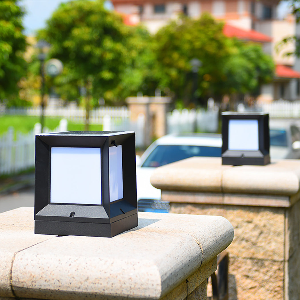 Modern Square Solar Pillar Light – Featuring a sleek black aluminum frame and frosted acrylic panels, this stylish outdoor light comes with a top-mounted solar panel for efficient energy capture. Customize your ambiance with triple-color LED options (daylight, warm white, and cool white), easily switched via the included remote control. Enjoy flexible power choices: solar charging for 8–10 hours of soft nighttime glow or wired installation with an E27 bulb for steady brightness—both controllable by remote.