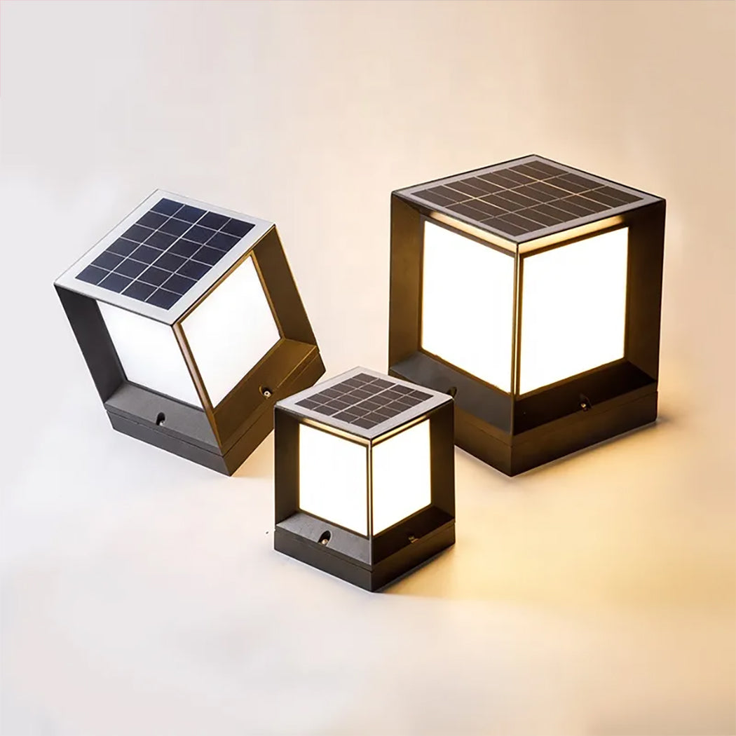The image displays three cube-shaped solar lights with integrated top-mounted solar panels and softly glowing side panels. Their distinctive square frame sets them apart in a market dominated by rounded designs, making them an elegant choice for gates, gardens, or porch pillars.