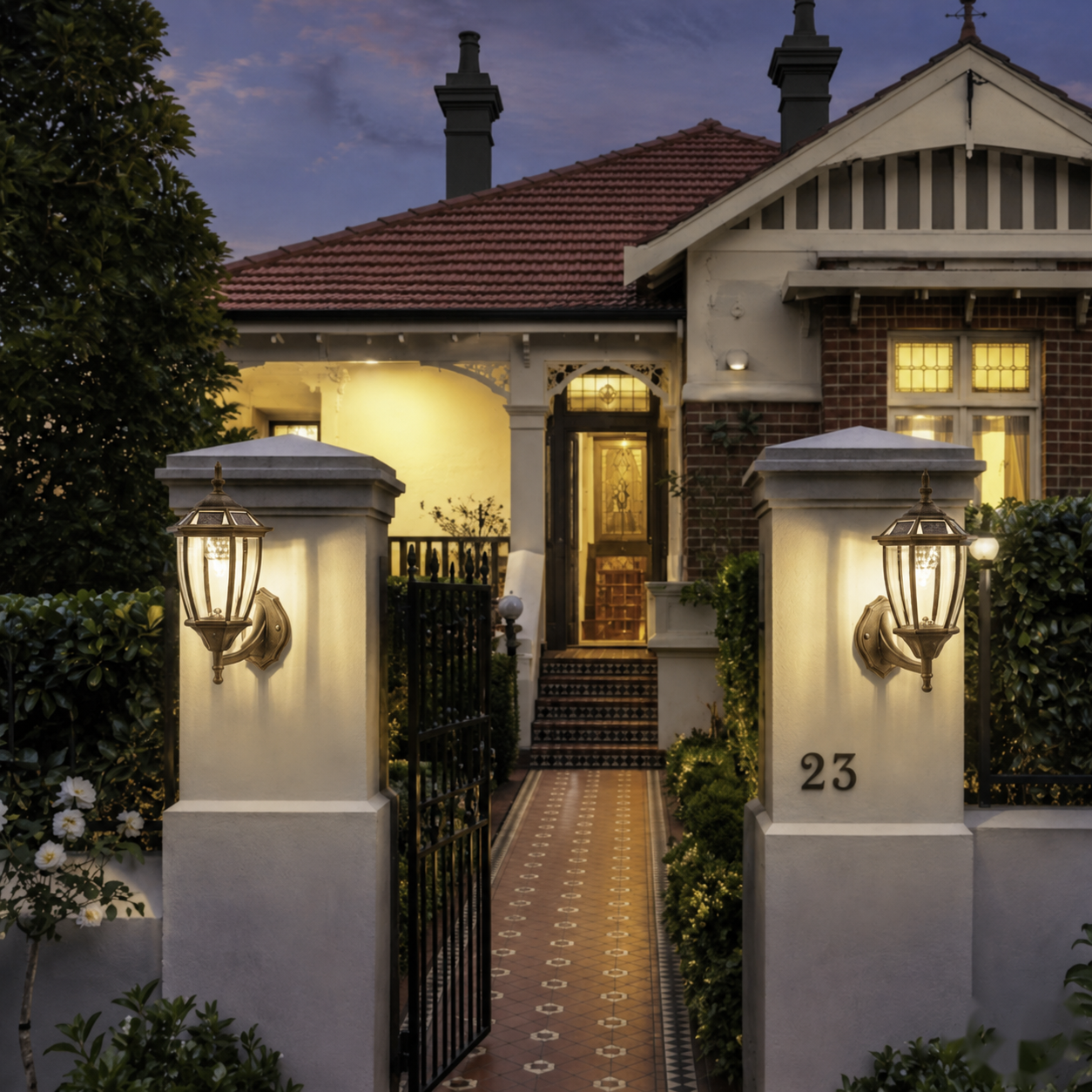 Classic Solar Coach Lantern wall-mounted lights installed on concrete entrance pillars at a traditional Victorian-style Australian home front gate.