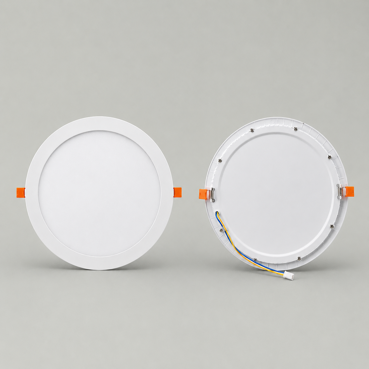 Front and back view of a white 30cm round LED solar skylight ceiling panel, displaying the clean frosted diffuser face, orange spring retaining clips, and rear wiring connector port.