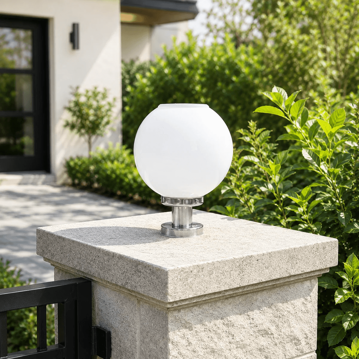Round Ball Solar Gate Light with a silver bracket mounted on a stone driveway entrance pillar in Australia