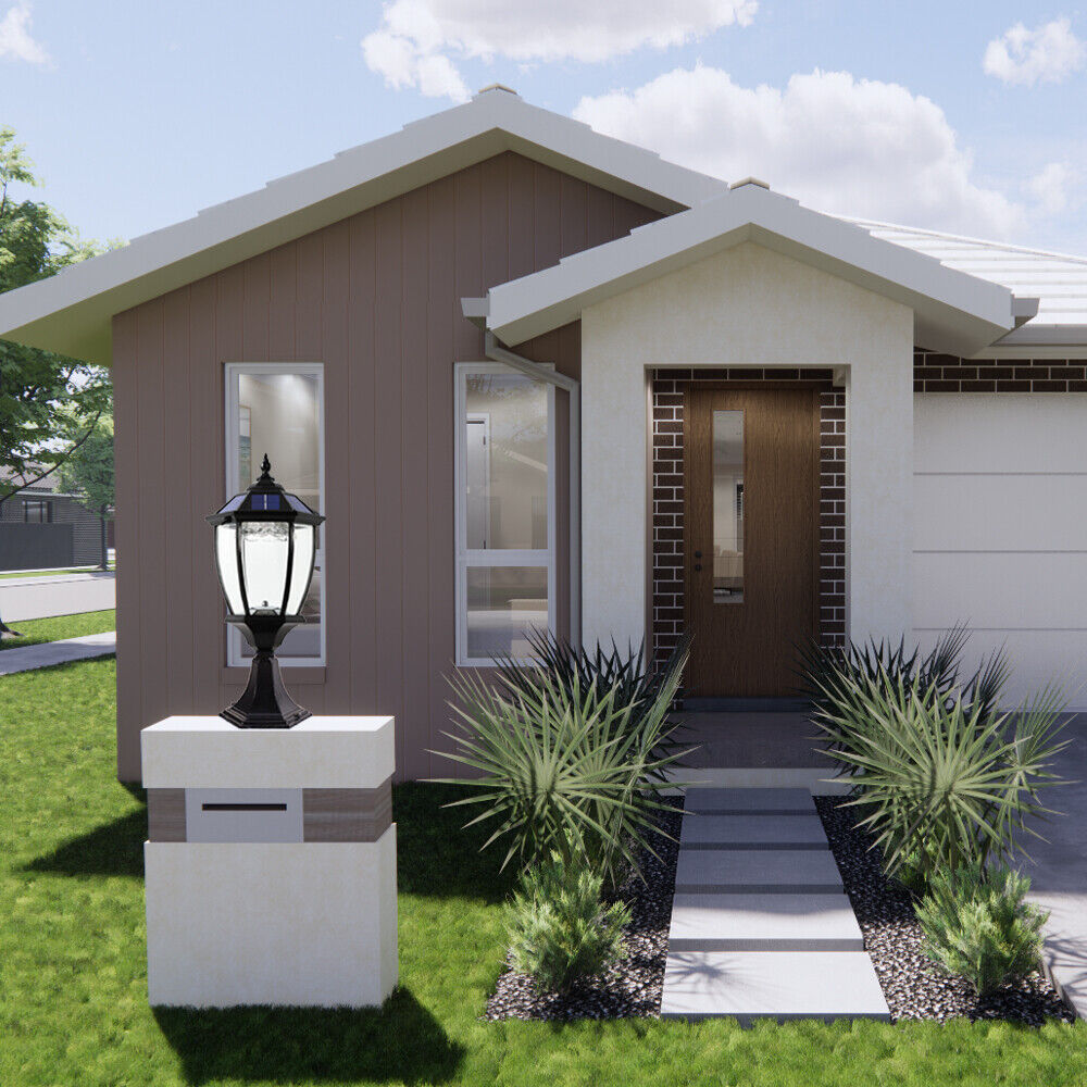 Elegant black solar post lamp with clear glass panels, mounted on a white pedestal beside a front garden path, standing out against the backdrop of a modern house with a brown-and-white exterior and manicured landscaping.