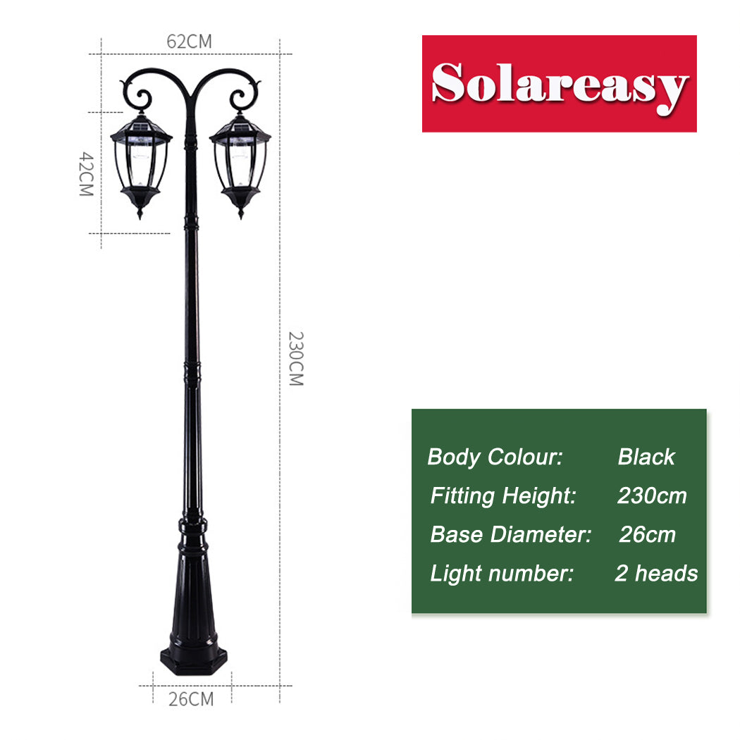 Black solar street light with dual lantern heads mounted on a decorative pole, each lantern featuring clear glass panels. The light stands 230 cm tall, with lanterns 42 cm high and spaced 62 cm apart side to side. Ideal for outdoor use in streets, gardens, or pathways.