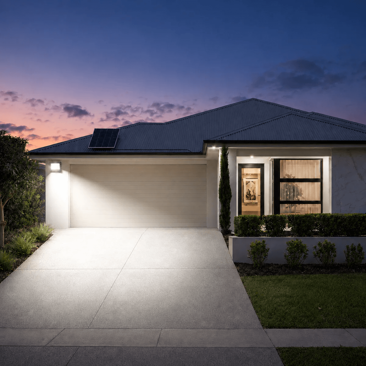 60W solar powered security lights mounted on a house exterior wall. Bright solar outdoor spotlight lighting a driveway.