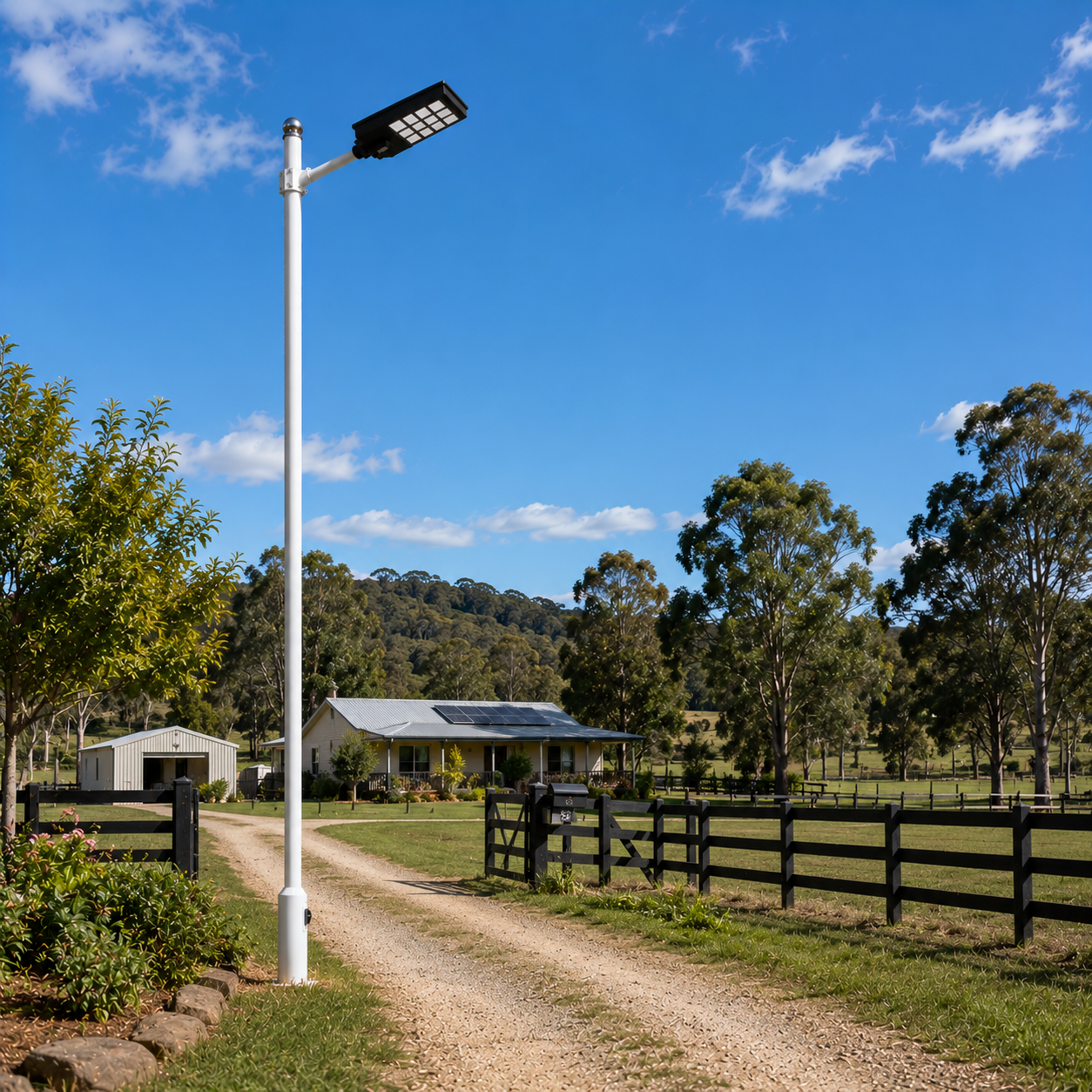 Solar powered street light installed on a white pole illuminating a rural farm front gate and property entrance in Australia