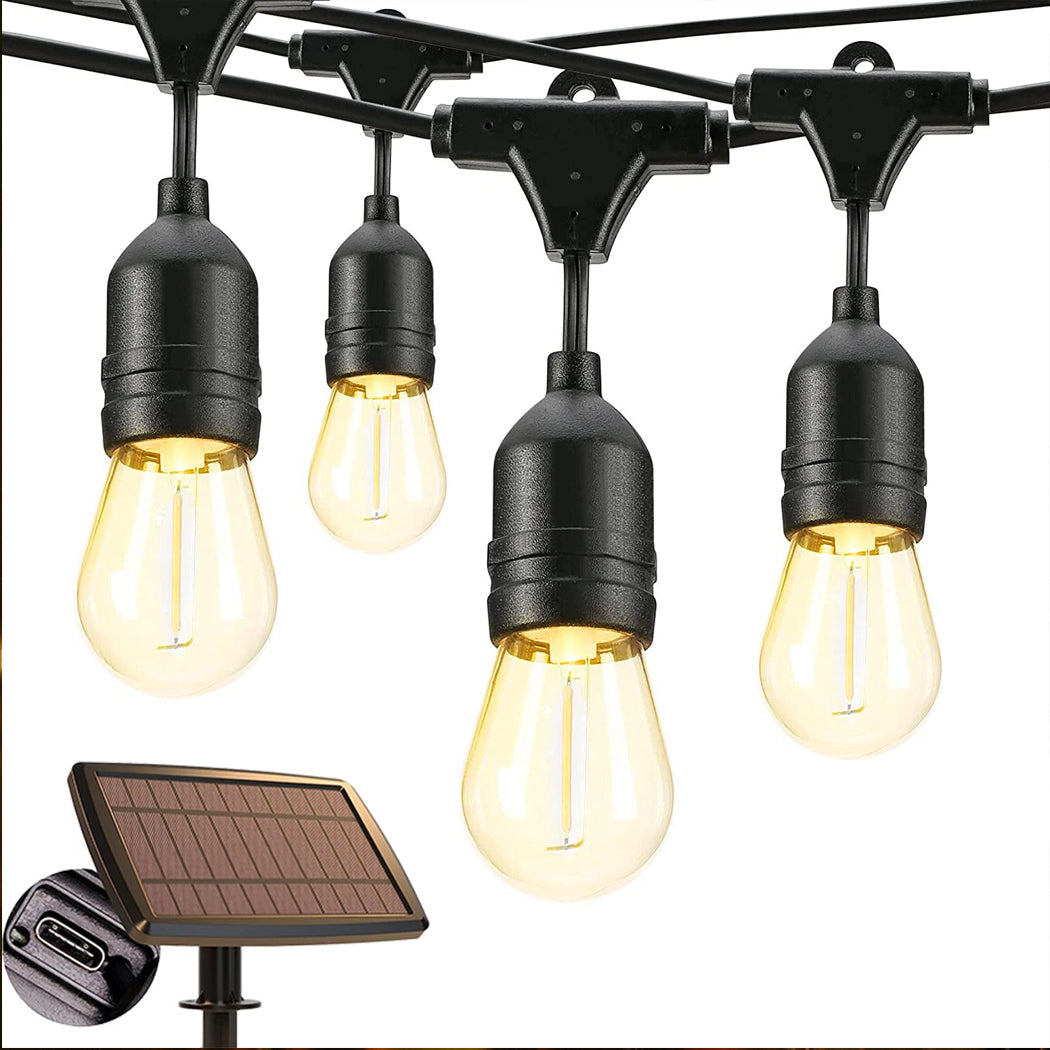 Close up view of solar powered outdoor string lights with a dual charging system showing hanging vintage bulbs a ground stake panel and an integrated micro USB input port for flexible use across Australia