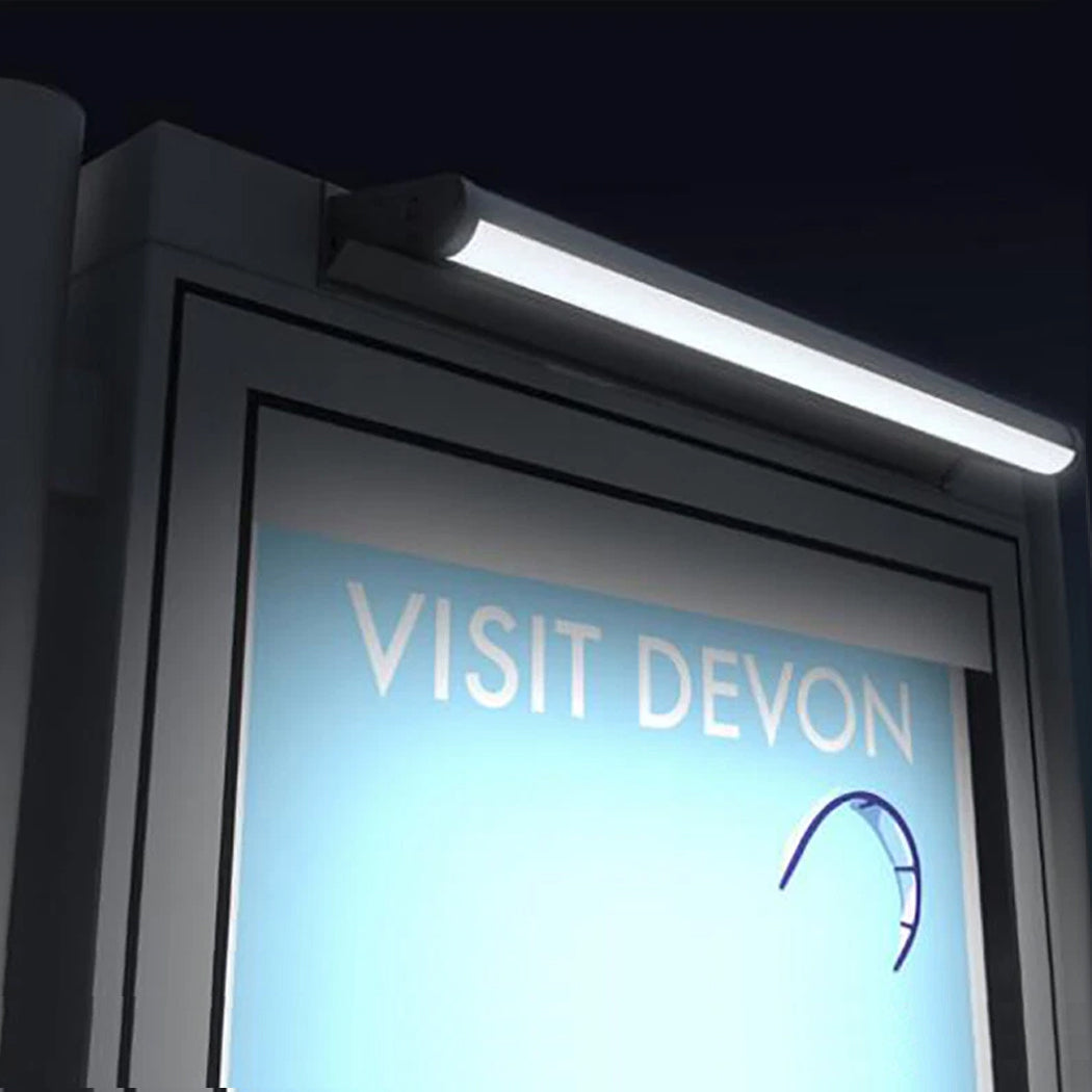 Nighttime view of a billboard illuminated by a solar-powered LED light mounted above the display. The fixture casts bright, even light across the sign, enhancing visibility in low-light conditions. Its integrated solar panel enables energy-efficient, off-grid operation, ideal for outdoor advertising and promotional signage