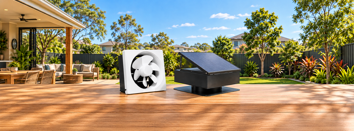 Wall-mounted solar ventilation fan and roof exhaust fan displayed in a sunny backyard