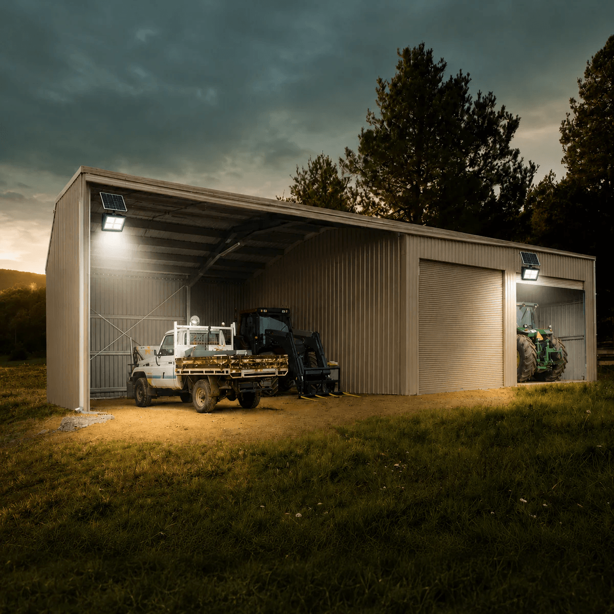 100W solar floodlight illuminating a corrugated metal farm shed and farm machinery. Outdoor solar security lights for rural properties.