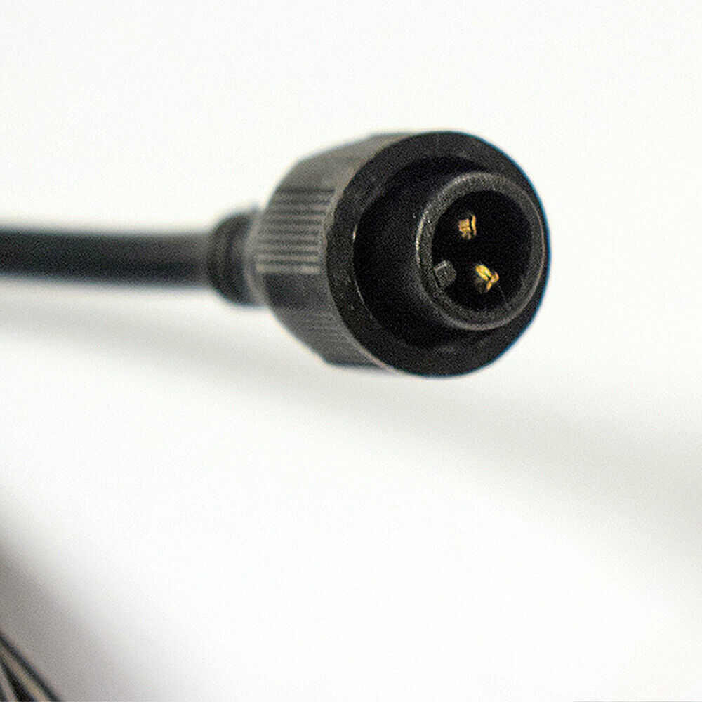 Macro close-up of a 2-pin male connector terminal head with gold-plated pins on a black waterproof solar extension cord.