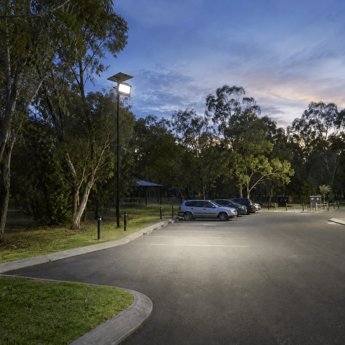 High-output 300W solar security light pole mounted in a commercial outdoor car park, delivering wide-area illumination across parking bays.