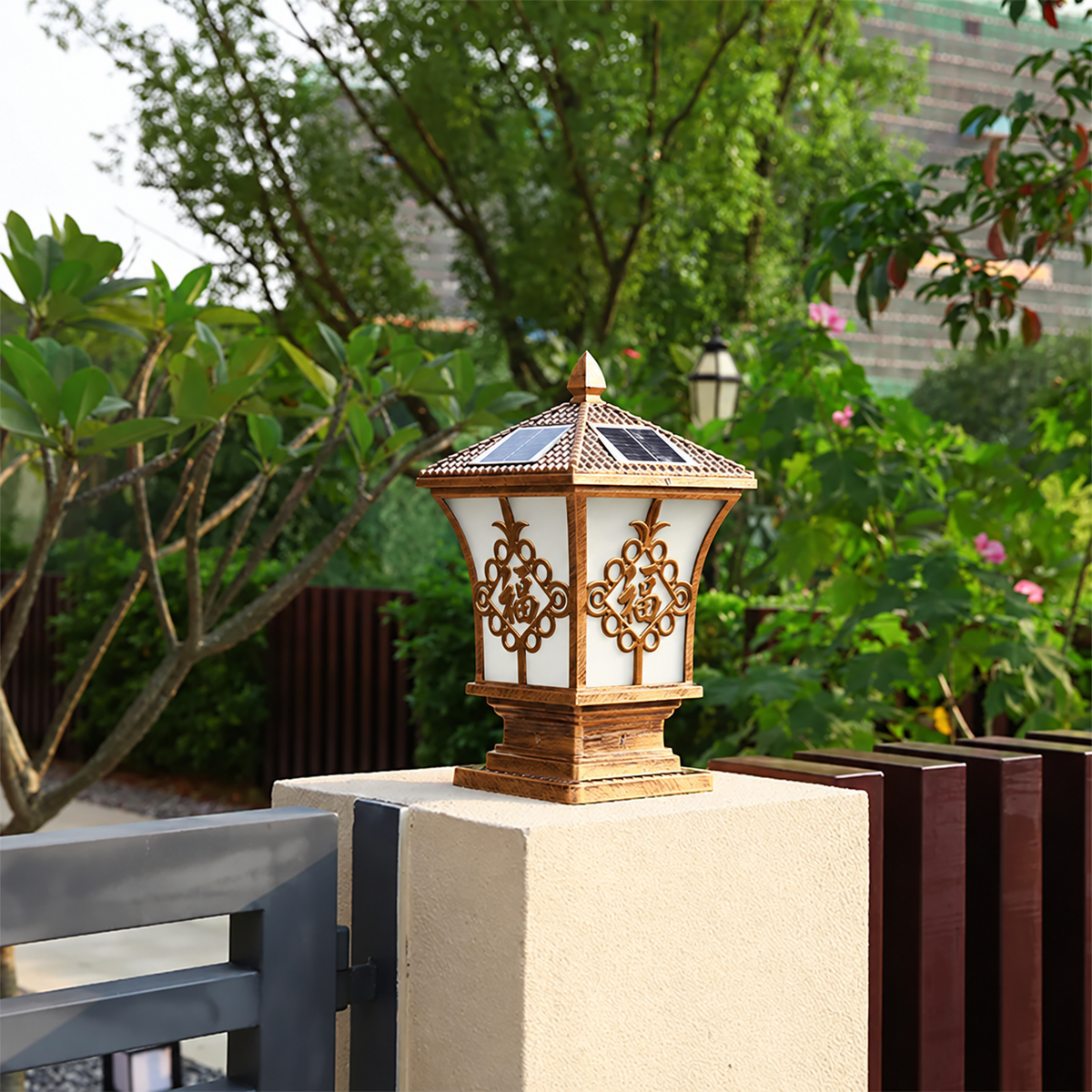 Bronze heritage solar coach lamp mounted as a gate pillar post light on a garden driveway fence in Australia.