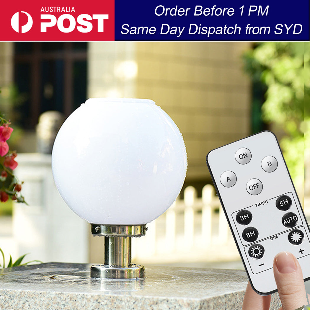 Outdoor solar globe light mounted on stainless steel base, shown in garden setting with remote control in hand to highlight wireless operation and adjustable lighting features