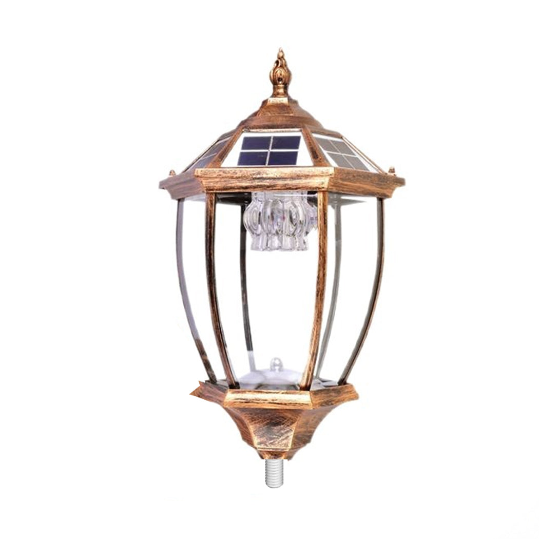 Antique bronze solar lantern head with integrated solar panels on the roof and a clear glass housing showing the inner LED lighting fixture.