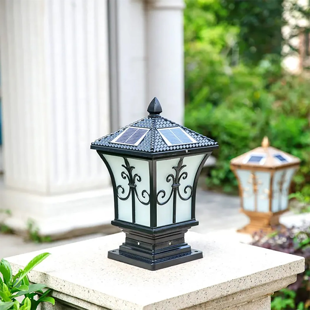 Black heritage solar coach lamp installed as a pillar post and gate light on a stone pillar in Australia.