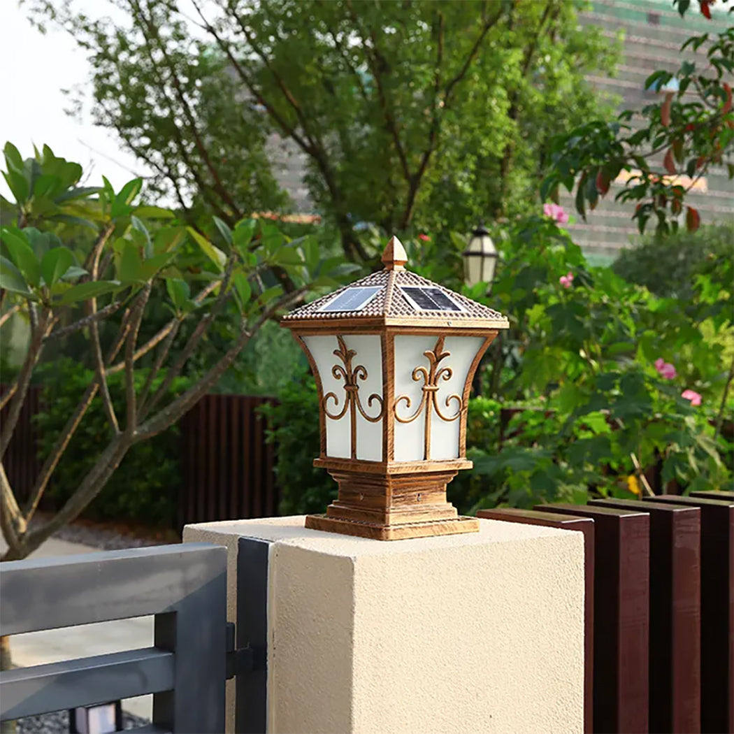 Bronze heritage solar coach lamp mounted as a gate pillar post light on a garden driveway fence in Australia.