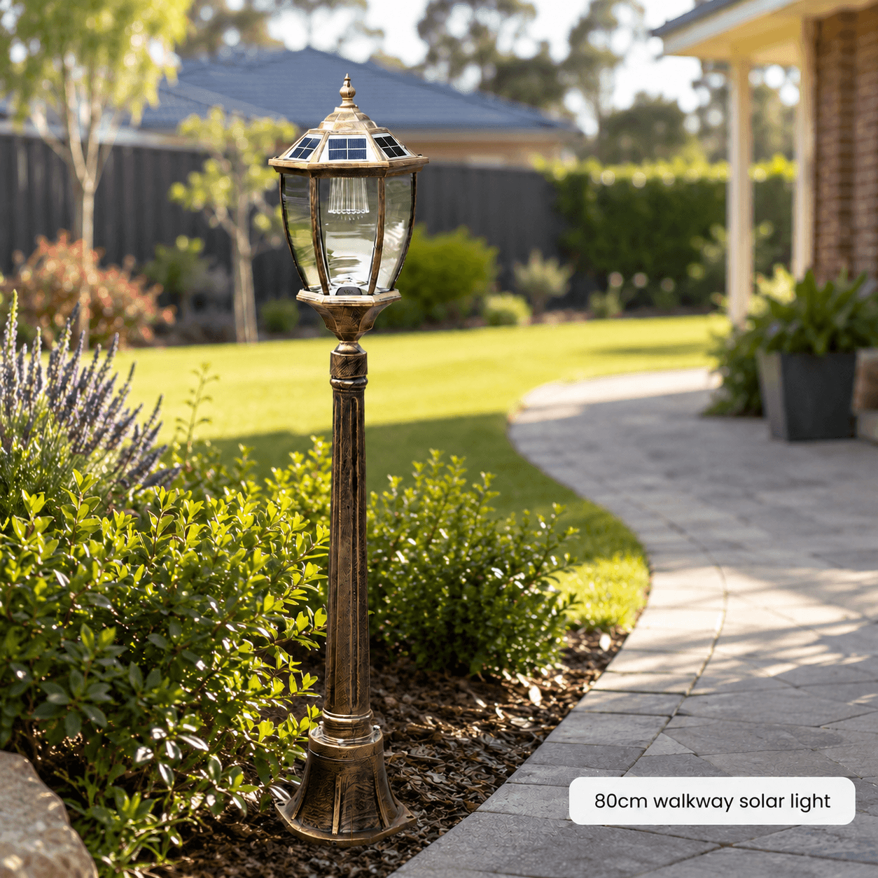 An eighty centimeter bronze solar pathway post light installed in a garden bed near a walkway to serve as a decorative solar garden light.