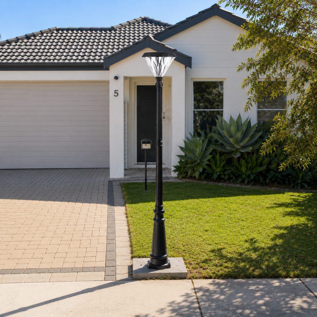 Sleek flat top solar light post mounted along a paved driveway and lawn entrance of a modern suburban australian home.