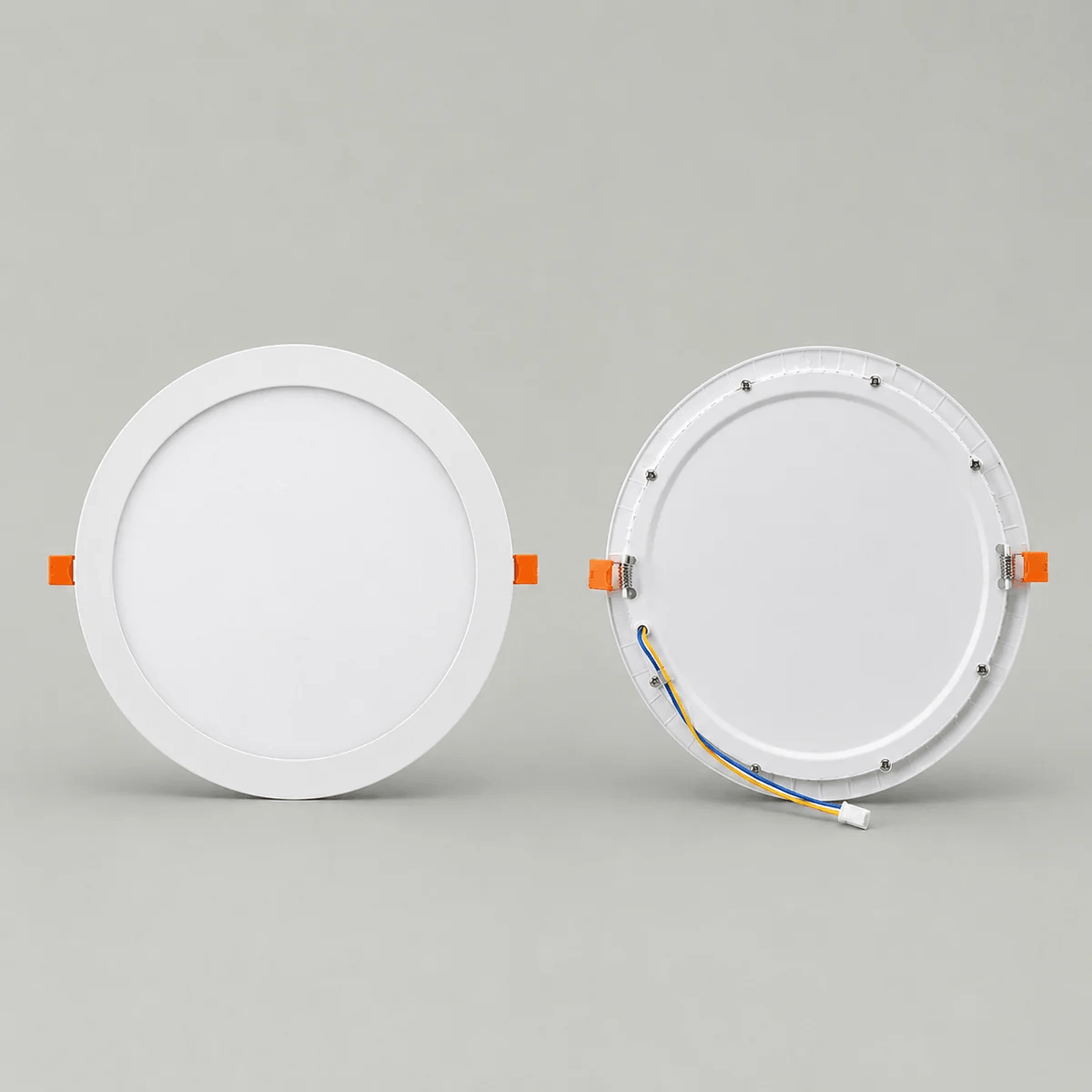 Front and back view of a white 30cm round LED solar skylight ceiling panel, displaying the clean frosted diffuser face, orange spring retaining clips, and rear wiring connector port.