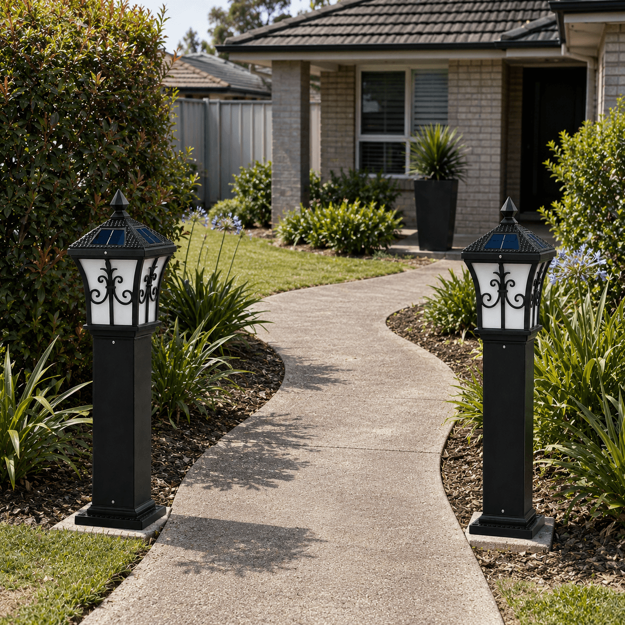 Solar lamp post outdoor setup featuring a pair of black walkway pillar lights framing a curved concrete front yard pathway leading to a brick house.
