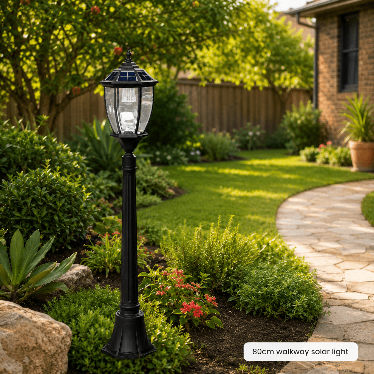 An 80cm victorian solar post light installed in a garden bed as a solar pathway post light along a stone walkway in Australia.