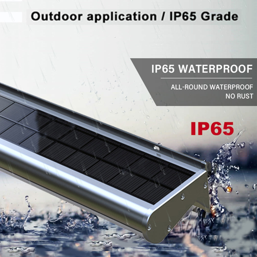Solar-powered LED light fixture mounted above a real estate for-sale billboard, operating in rainy conditions. The unit features an IP65 waterproof rating and rust-resistant design, ensuring reliable illumination for property signage in all weather. Its integrated solar panel supports energy-efficient, off-grid lighting for outdoor advertising.