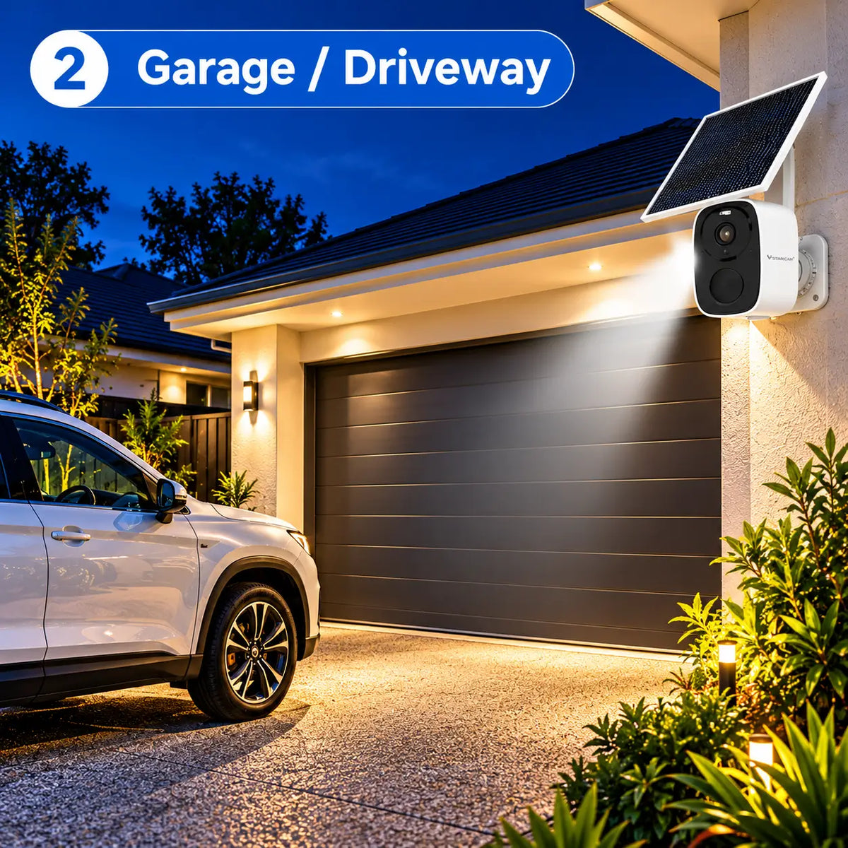 A close-up view of the wall-mounted Vstarcam BG55 solar security camera and its solar panel casting a bright, automated spotlight beam over a concrete driveway apron and parked vehicle outside a dark residential garage at night.